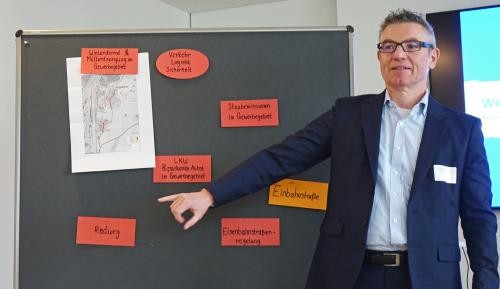 Unternehmerfrühstück Wirtschaftsförderer Christoph Hodapp zeigt auf eine Tafel